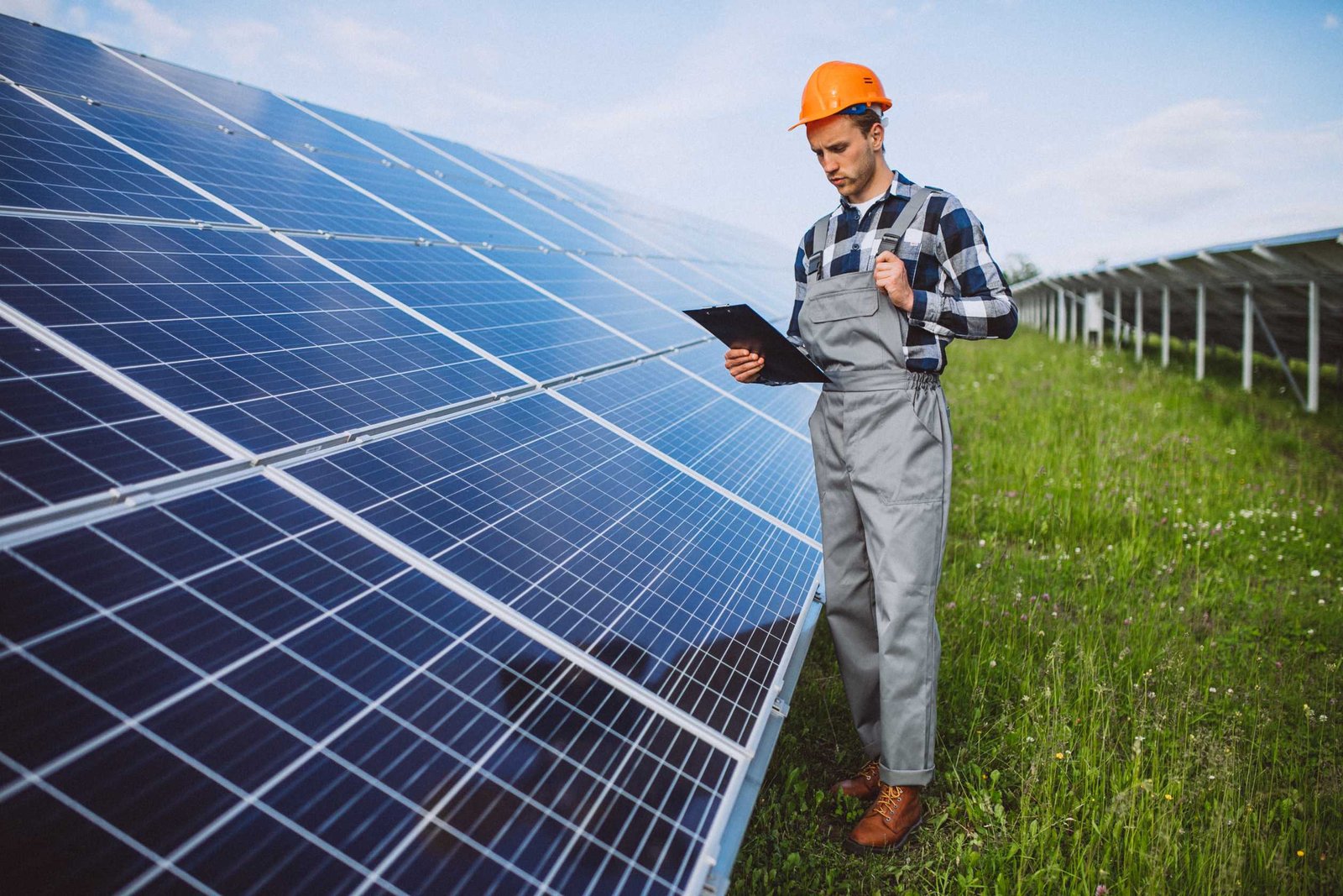 man worker firld by solar panels